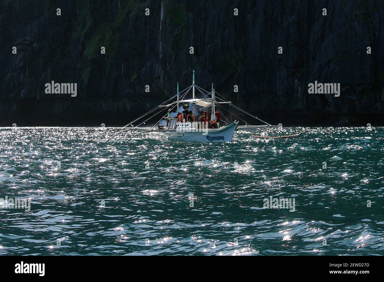 A ferry carrying tourists sails in Palawan Province, the Philippines ...