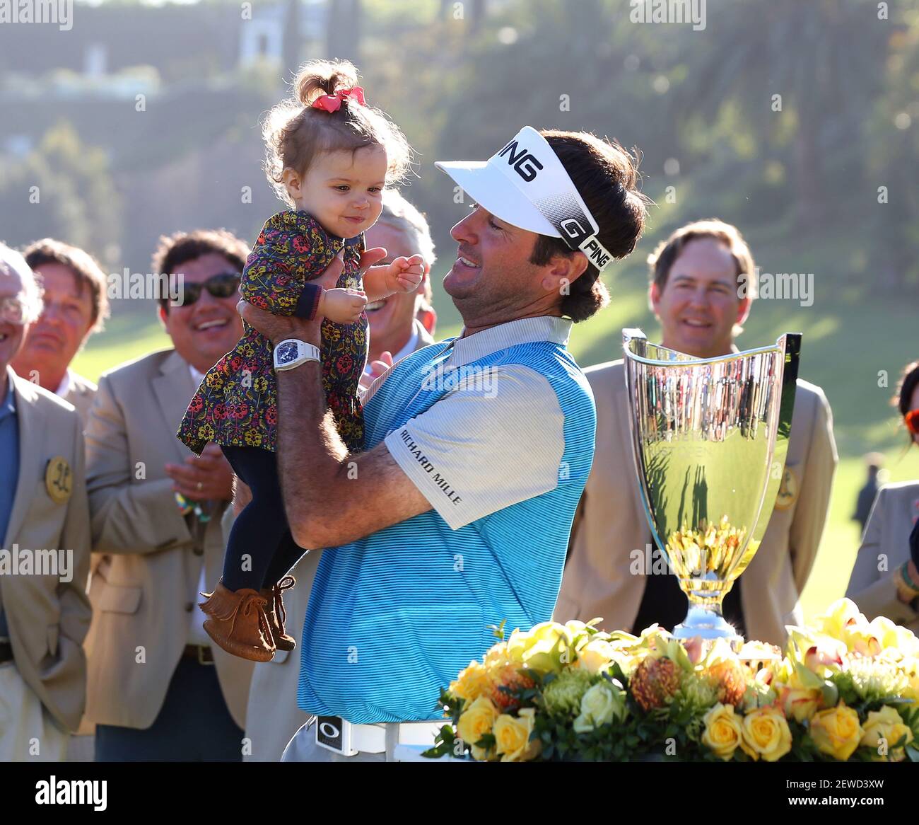 Bubba Watson picks up his daughter after she ran onto the green after winning the Northern Trust Open at Riviera Country Club in Pacific Palisades, California. Charles Baus/CSM *** Please Use Credit from Credit Field *** Stock Photo