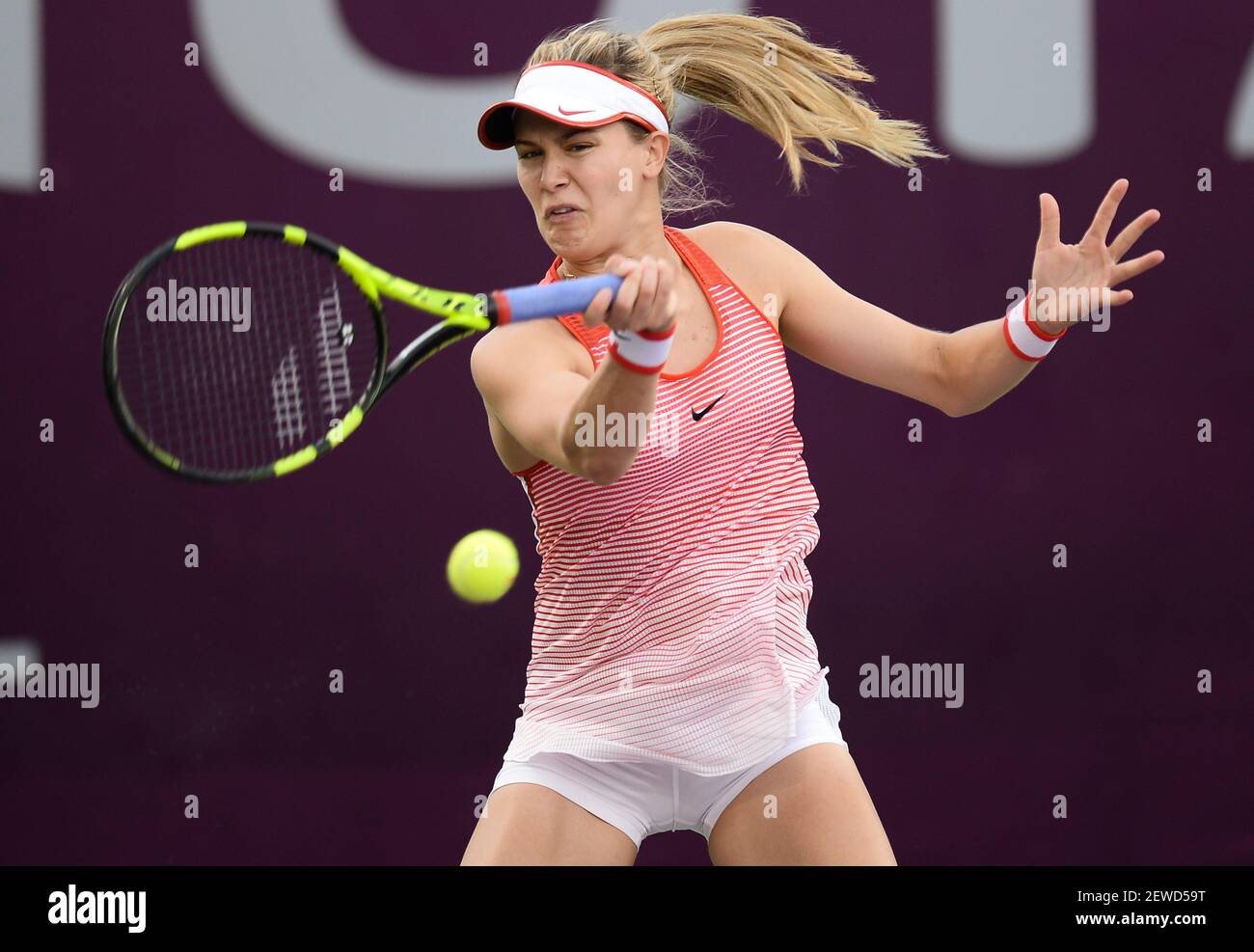 Eugenie Bouchard of Canada return the ball during the women's singles  fourth day match against Shuai Zhang of China ahead of WTA Qatar total Open  2016 at the International Khalifa Tennis Complex
