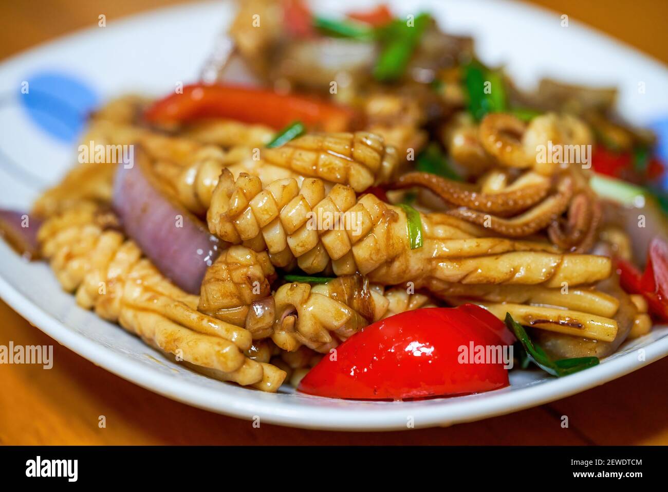 Chinese home cooking, fried squid with colored pepper Stock Photo Alamy