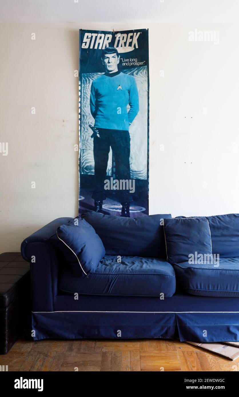 A vintage and worn Star Trek poster hanging above a couch in an abandoned apartment building. Ontario, Canada. Stock Photo