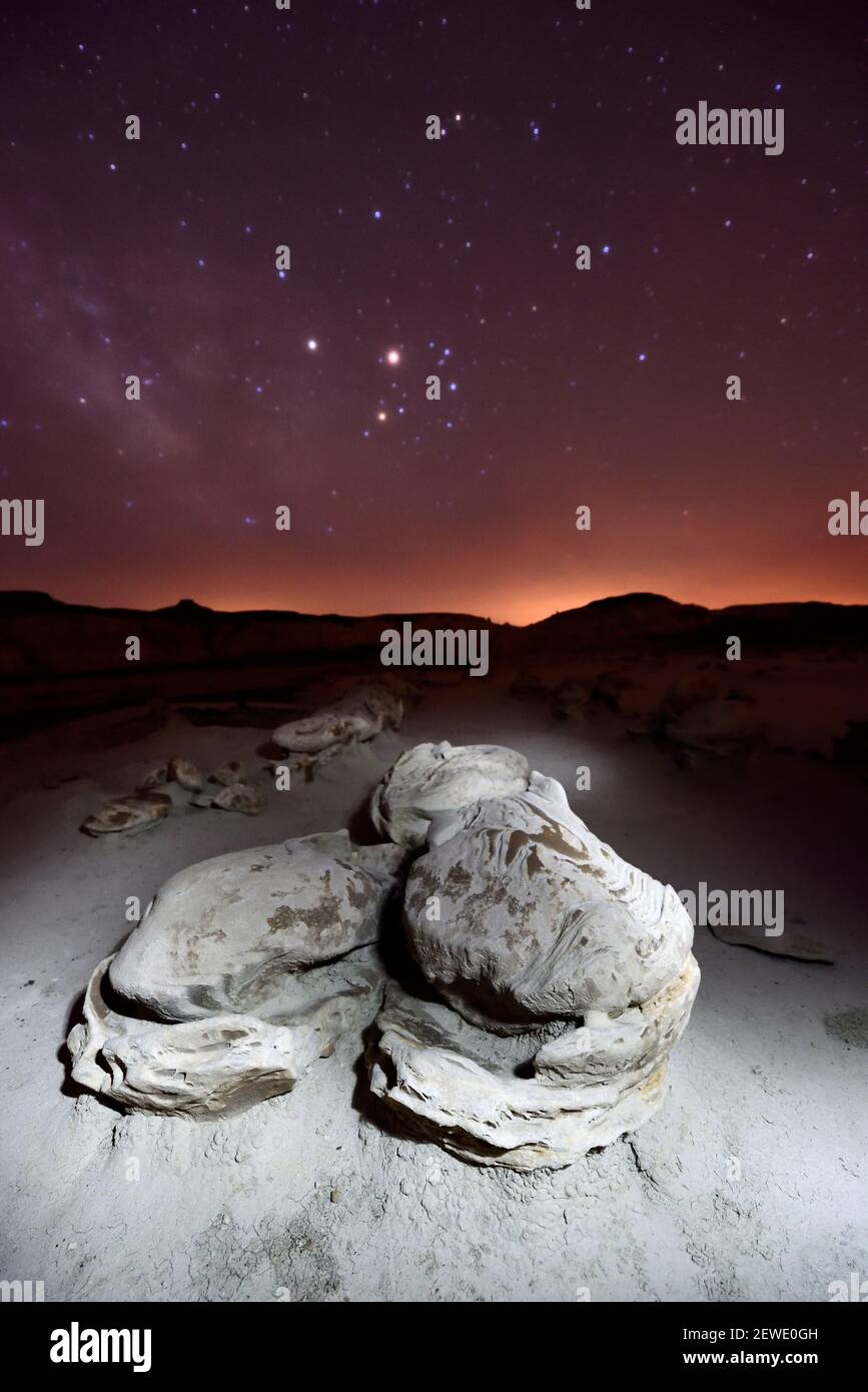 The night sky radiates over formations in an area known as the Alien Hatchery in the Bisti/De-Na-Zin Wilderness in New Mexico pictured on April 10, 2016. The area was once a delta that lay to the west of the Western Interior Seaway 70 million years ago, and the badlands  were formed by the erosion of the sandy Ojo Alamo Formation. (Photo by Alex Milan Tracy) *** Please Use Credit from Credit Field *** Stock Photo