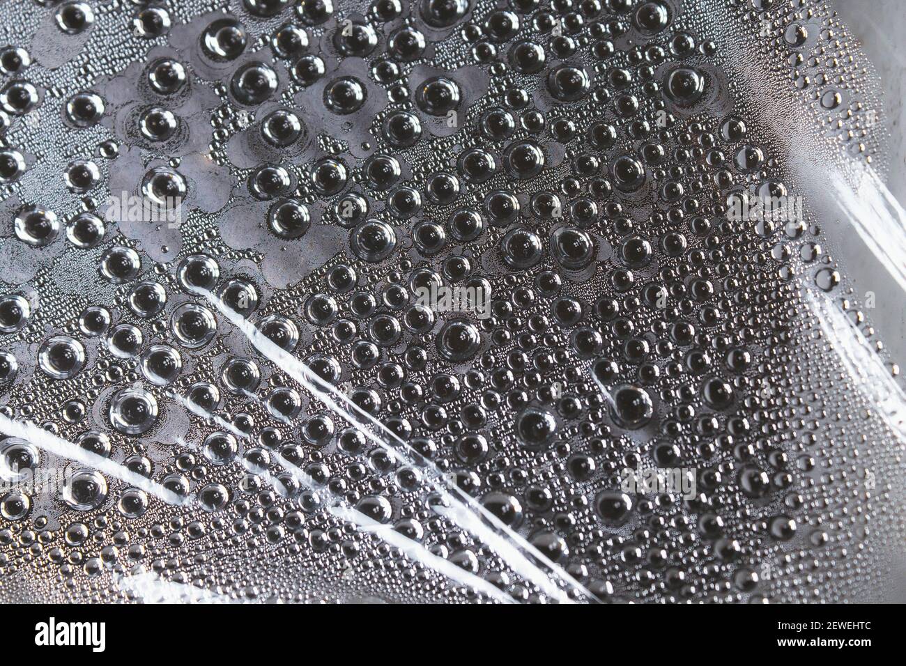 Water droplets on the film. Evaporation of moisture on a transparent