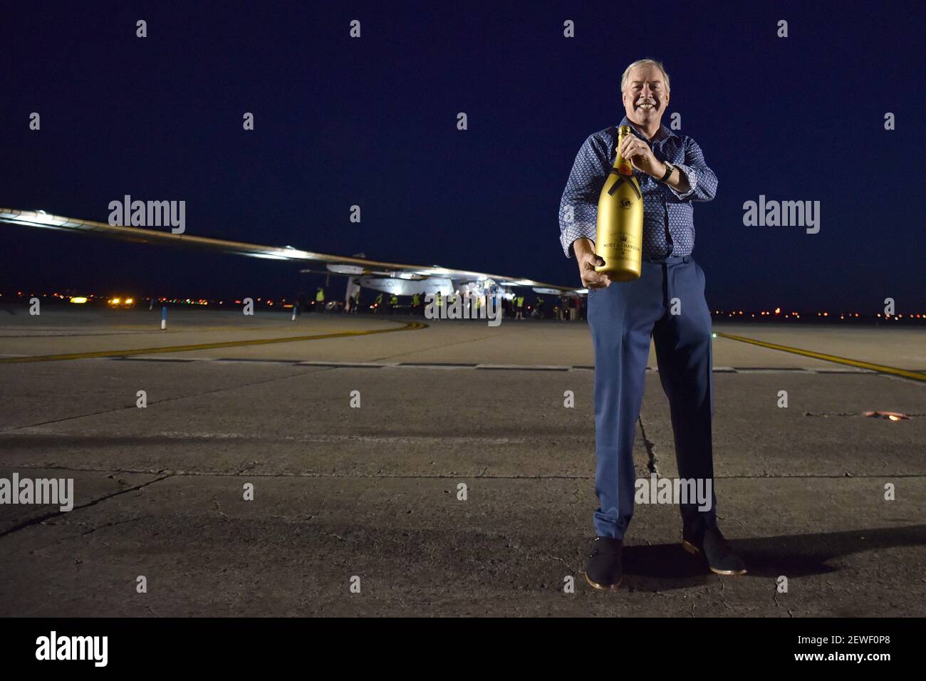 Jim Clerkin, CEO of Moet Hennessy, poses near the sun-powers Solar Impulse  2 after landing at JFK International Airport in New York, NY, on June 11,  2016. Pilot Andre Borschberg arrived at