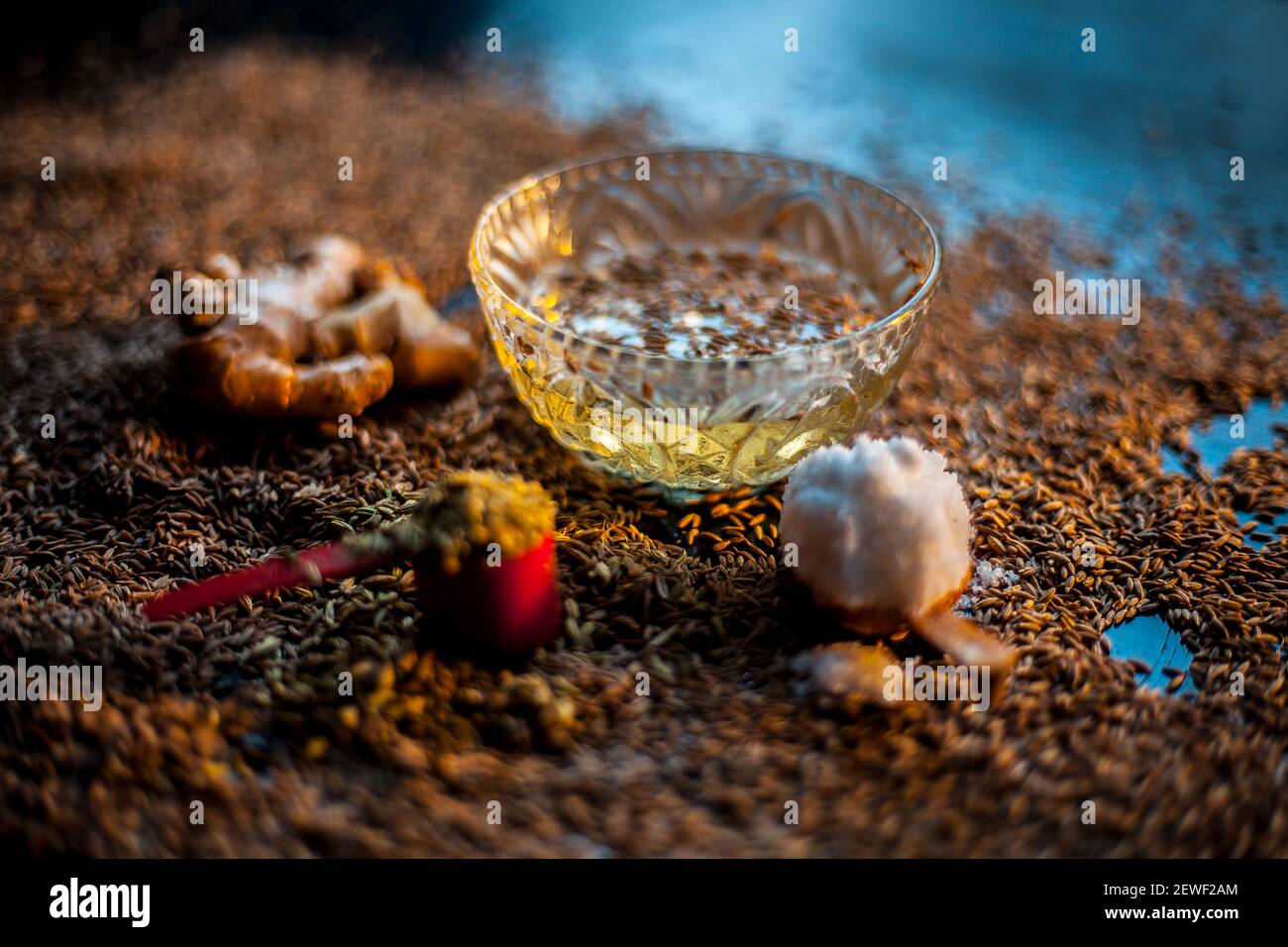 Shot of cumin seeds, sea salt, ginger powder,fennel seeds on brown