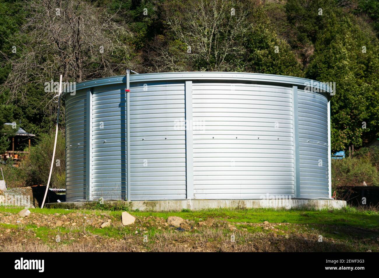 Large capacity corrugated steel water tank in rural neighborhood 