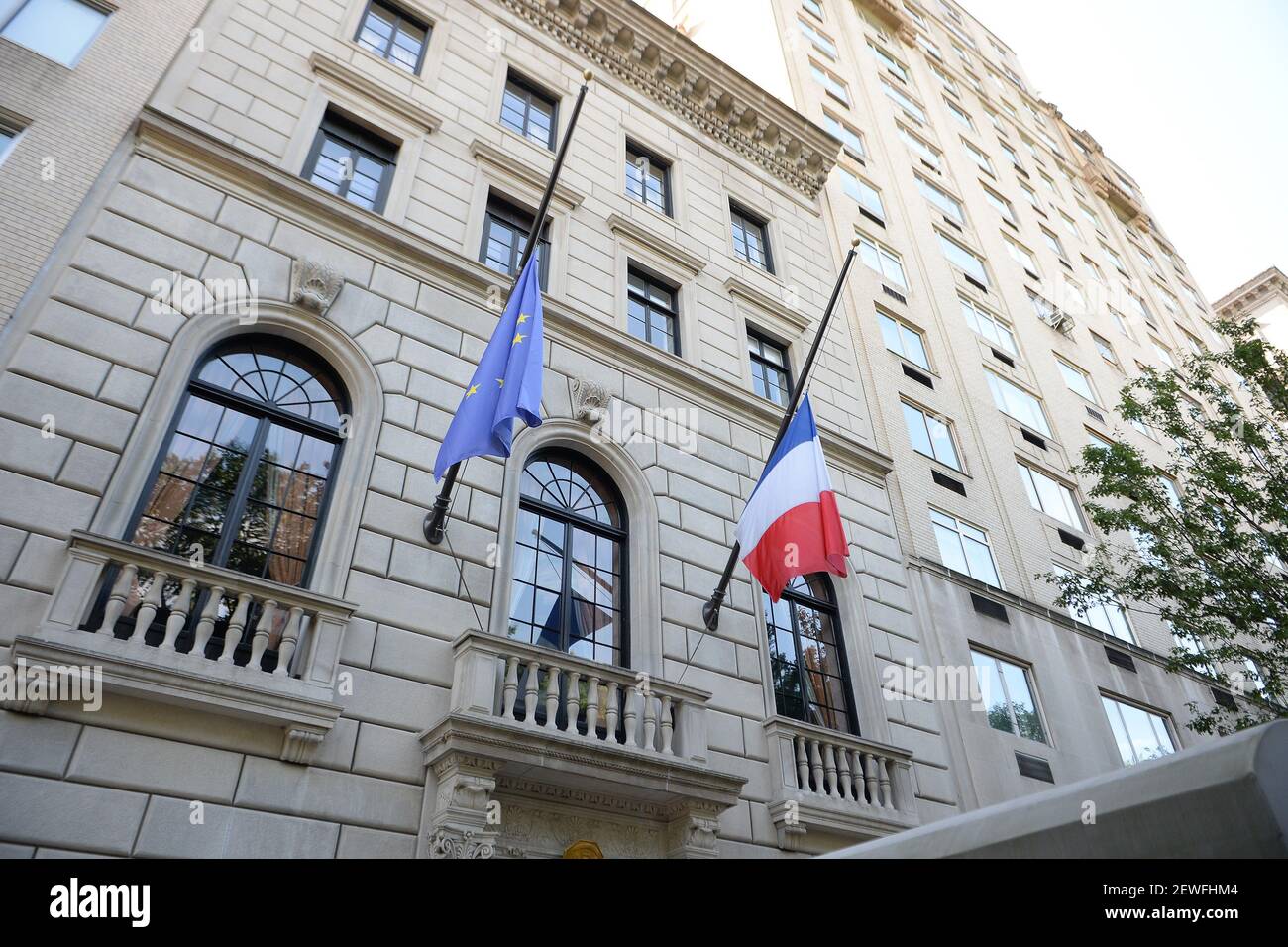 European Union and French flag fly at half-mast as New York City Police Department officers with the antiterrorism unit stand guard outside the French consulate in New York, NY, on July 15, 2016. A Frenchman of Tunisian descent drove a truck through crowds celebrating Bastille Day along Nice's beachfront, Thursday night, killing 84 people, including children. (Photo by Anthony Behar) *** Please Use Credit from Credit Field *** Stock Photo