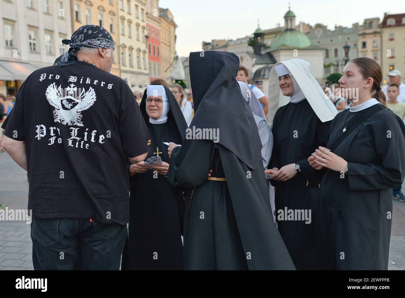 A group of nuns in discussion with a Pro Life Biker, as thousands of young Christian pilgrims start to arrive in Krakow, just a few days ahead of the 15th World Youth Day (WYD), where more then million young people from all around the world with meet with Pope Francis from 25–31 July 2016. On Friday, 22 July 2016, in Krakow, Poland. Photo by Artur Widak *** Please Use Credit from Credit Field *** Stock Photo