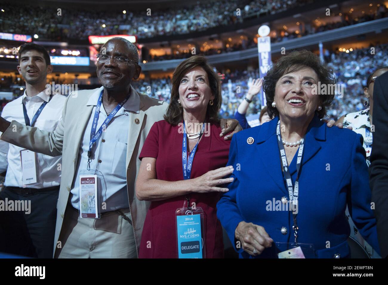 UNITED STATES - JULY 25: From left, Rep. Gregory Meeks, D-N.Y., New York Lt. Gov. Kathy Hochul, and Rep. Nita Lowey, D.N.Y., sing along with Paul Simon on the floor of the Wells Fargo Center in Philadelphia, Pa., on the first day of the Democratic National Convention, July 25, 2016.  Stock Photo