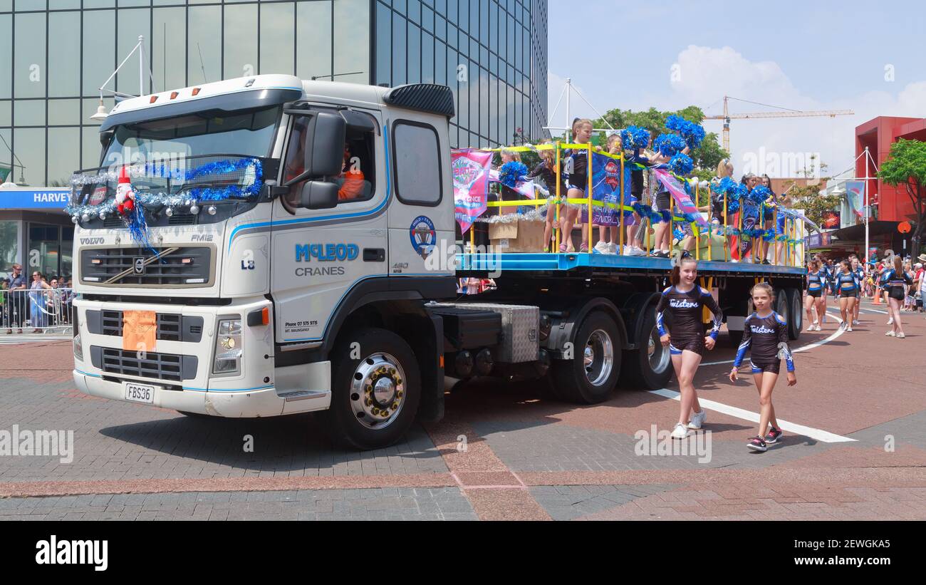 A group of cheerleaders riding in the back of a truck at a Christmas parade in Tauranga, New Zealand Stock Photo