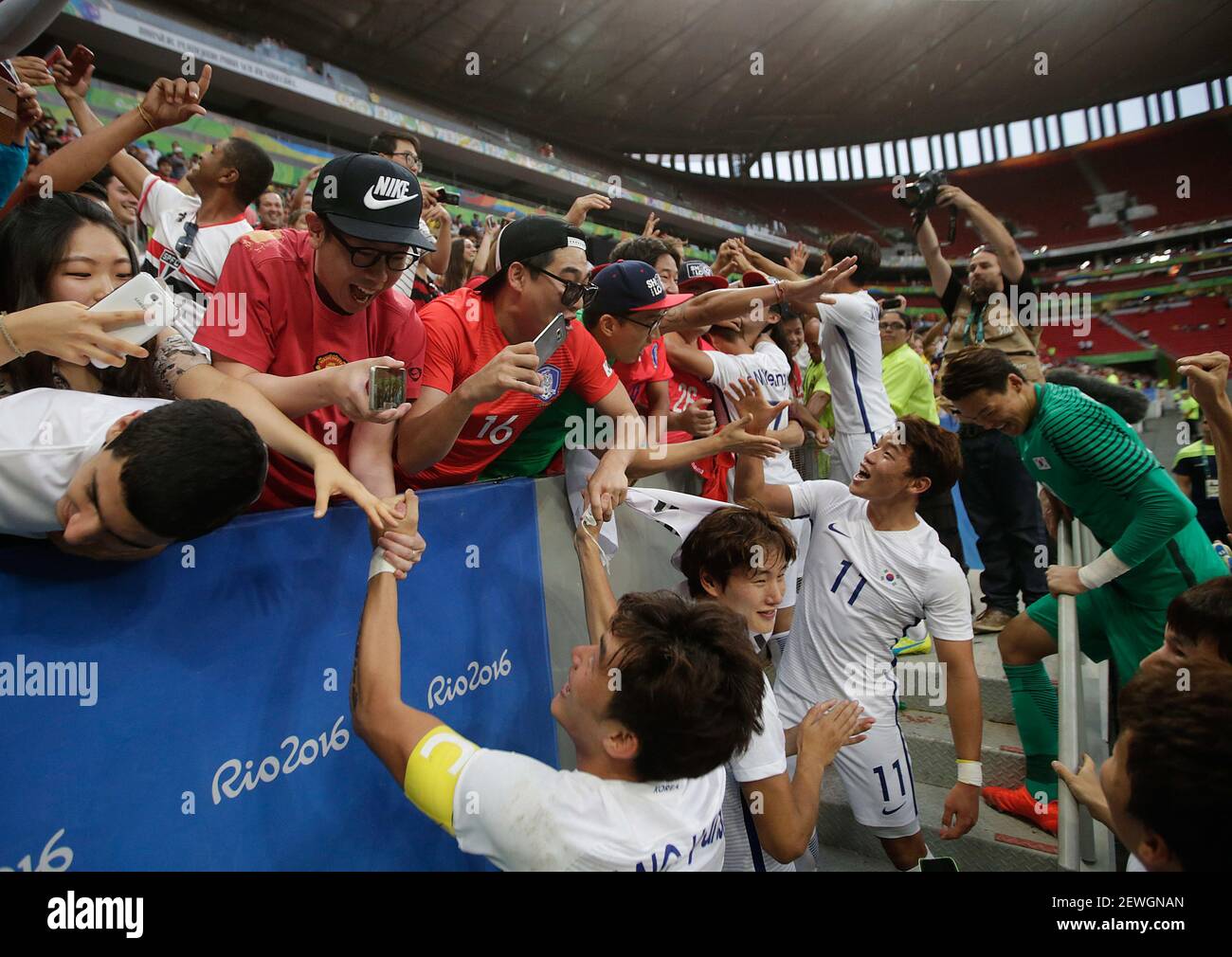 BRASÍLIA, DF - 10.08.2016: OLYMPICS 2016 FOOTBALL BRASILIA - Korea's pla  ces celebrate with the fans the victory of the match between Korea (KOR)  and Mexico (MEX) by GrC Olympic Mec Men's