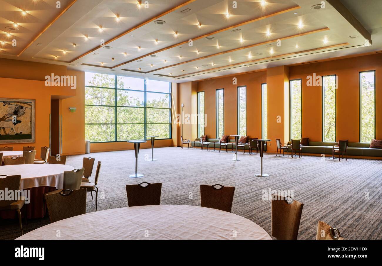 Large empty room in a hotel or conference centre, tables and chairs