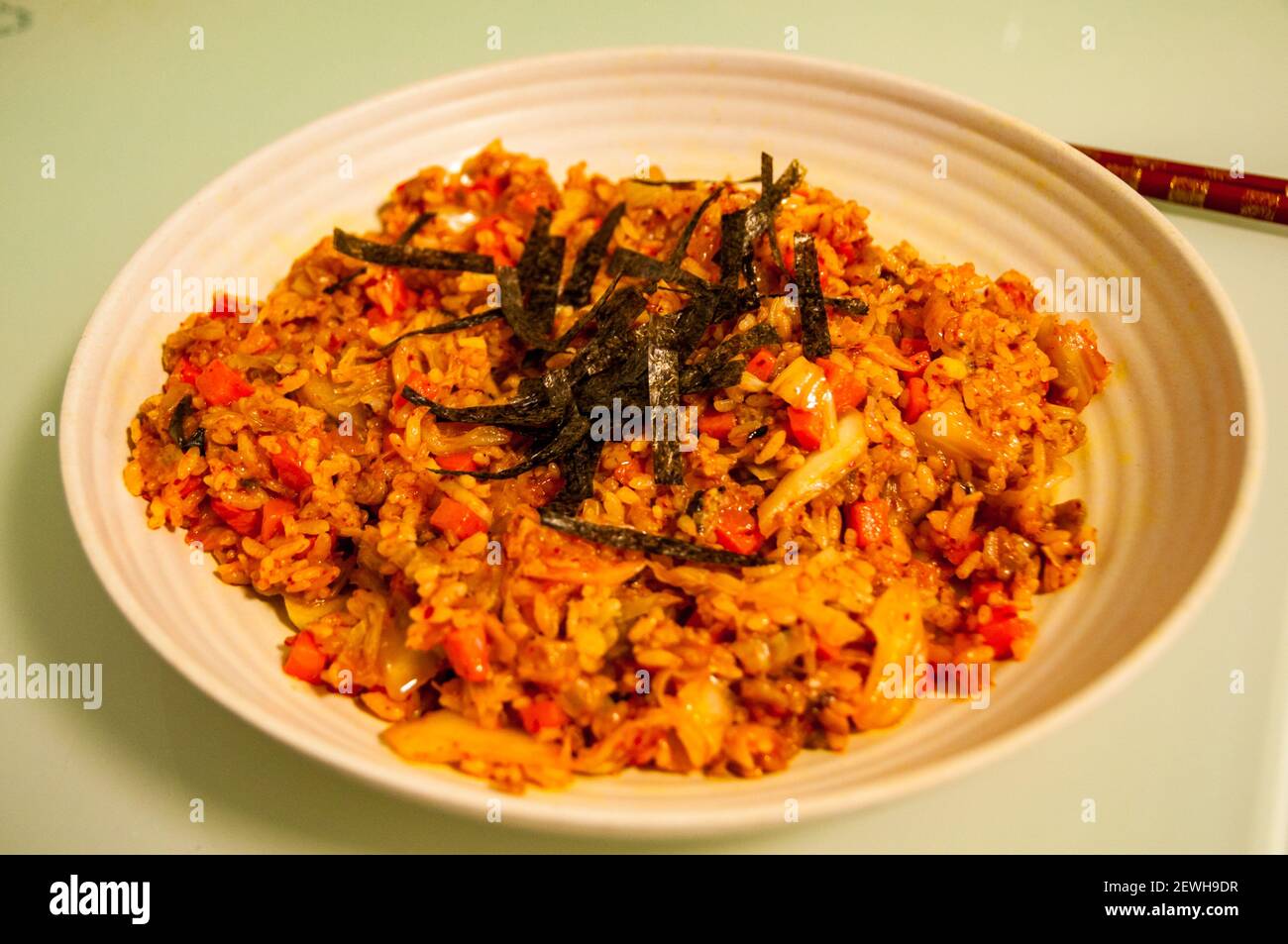 A home cooked dish of kimchi fried rice using Omipork a plant-based meat substitute in its ‘minced pork’ form. Stock Photo