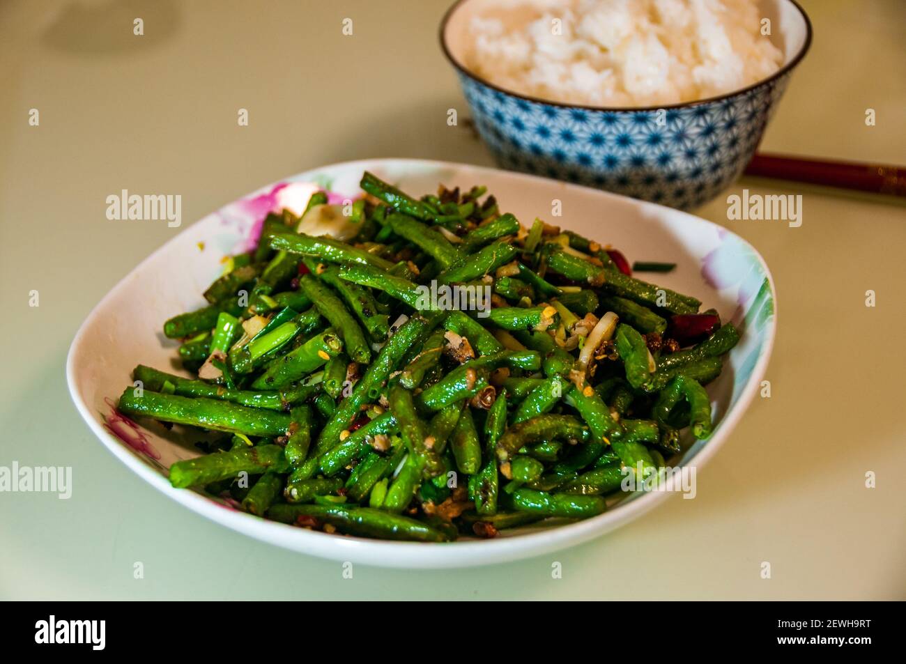 The Sichuan classic dish of dry fried snake beans cooked using Omipork a plant-based meat substitute in its ‘minced pork’ form. Stock Photo
