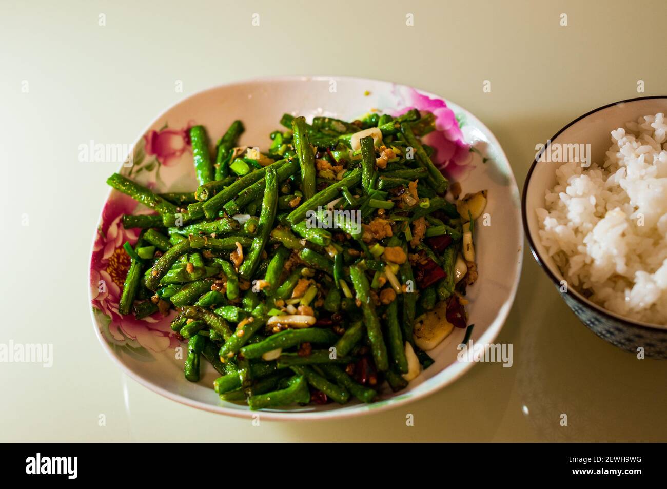 The Sichuan classic dish of dry fried snake beans cooked using Omipork
