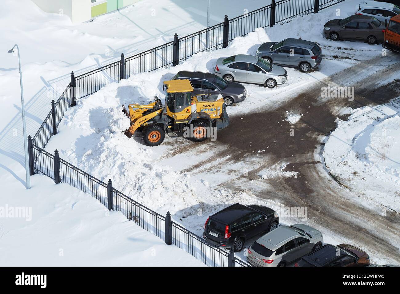 Snow removal equipment. Cleaning of streets and yards from snow. A dump