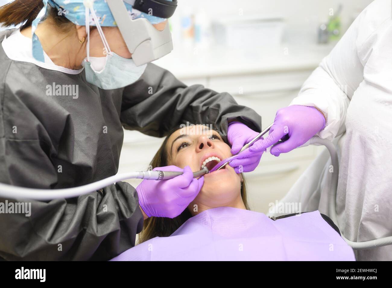 Young dentist working with female patient in a modern hospital. High quality photo. Stock Photo