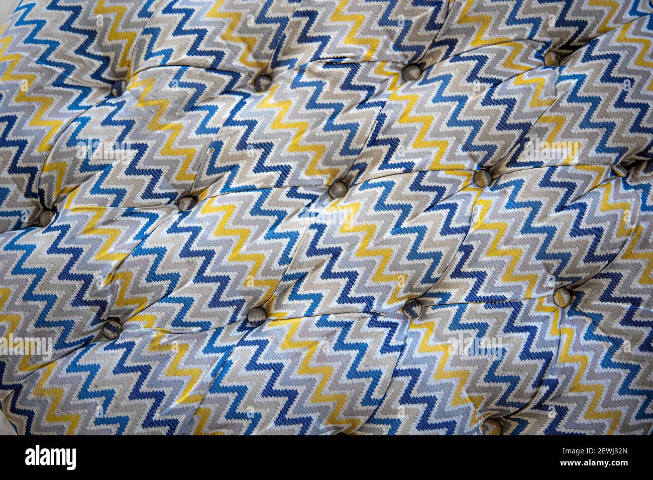 Close up of mottled soft sofa texture with sunken buttons. Idea and ...