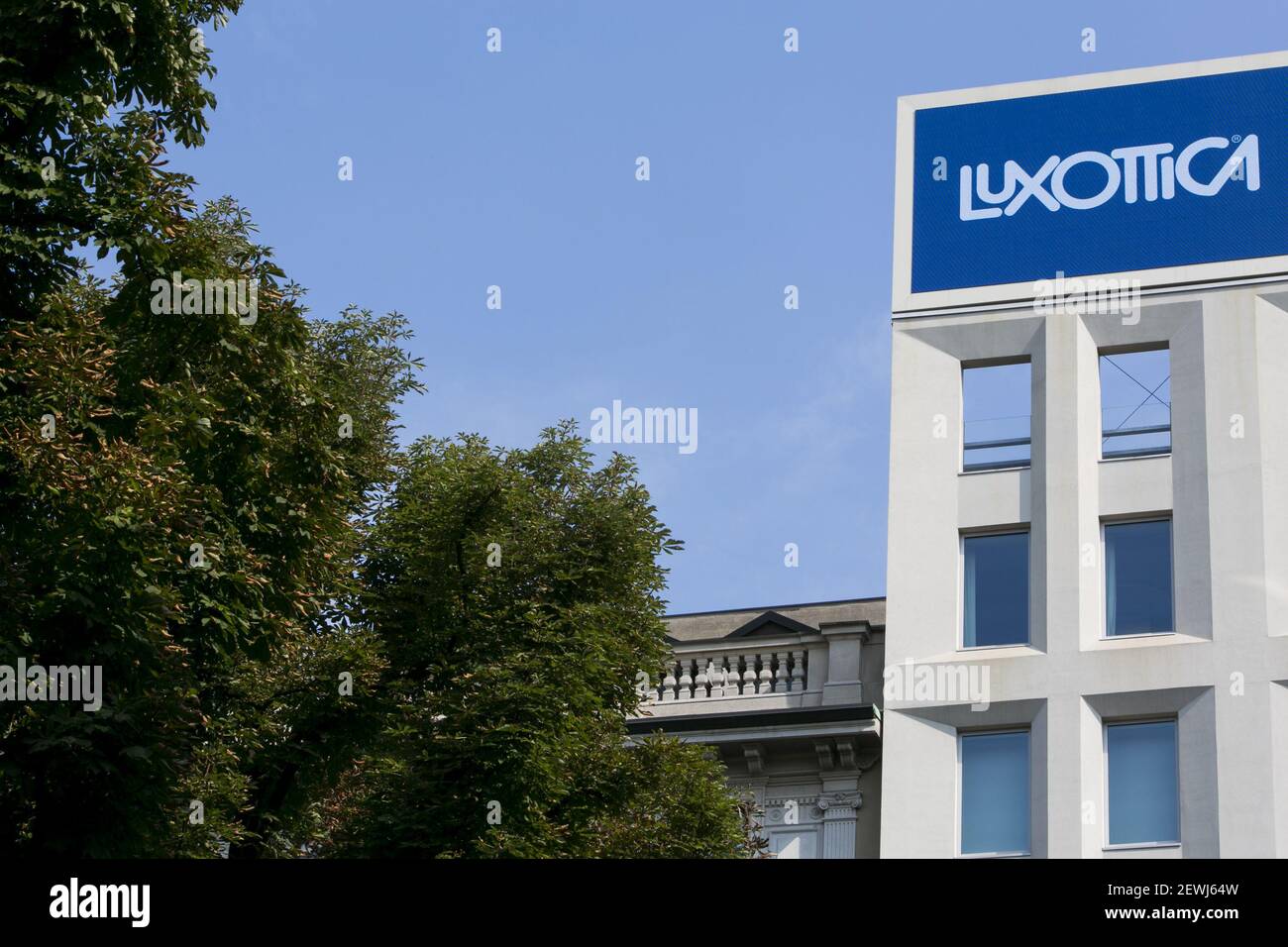 A logo sign outside of the headquarters of the Luxottica Group S.p.A