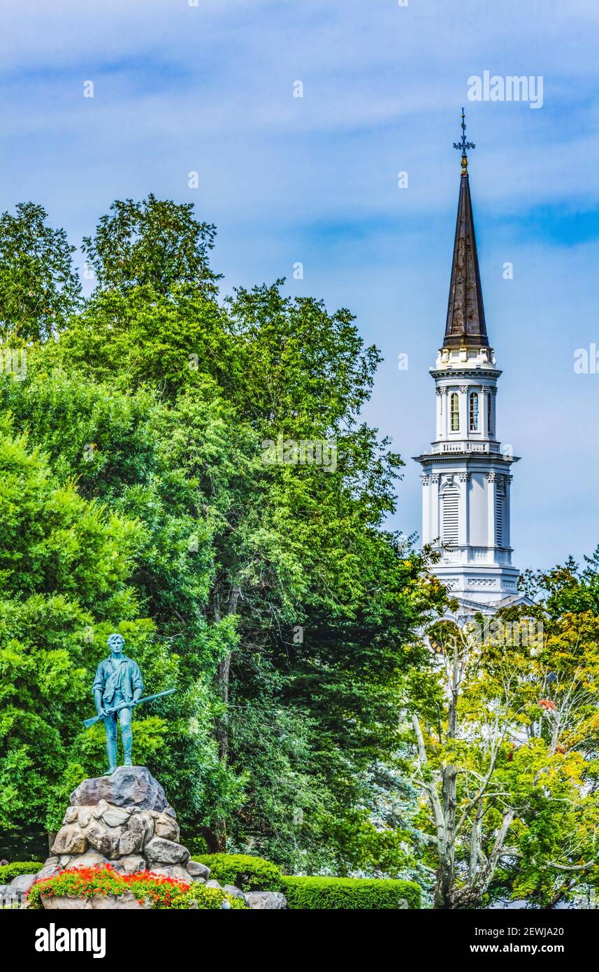 Lexington Minute Man Patriot Statue First Parish Church Spire Lexington Battle Green Massachusetts. Site of April 19, 1775 first battle of American Stock Photo