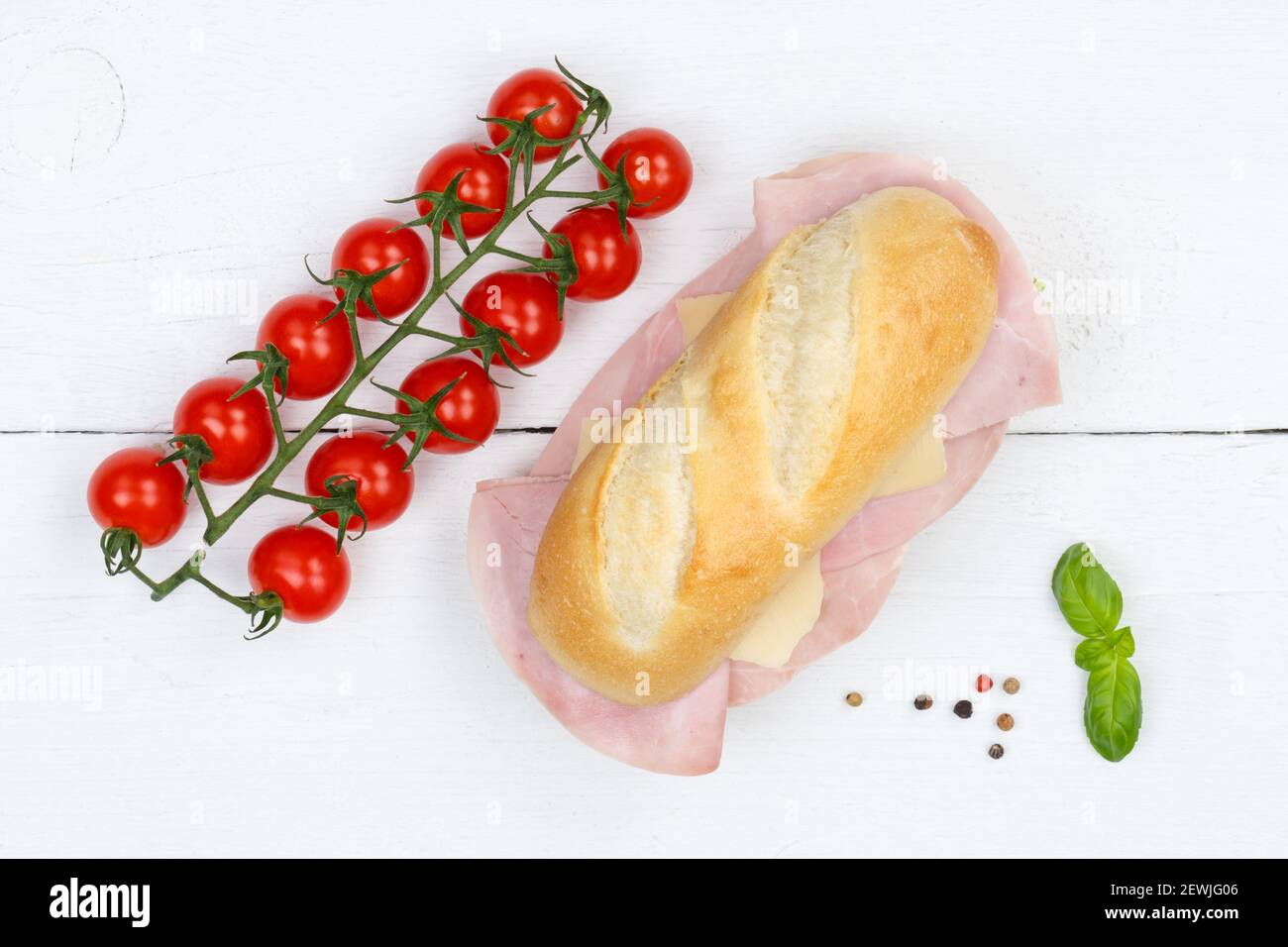 Sub sandwich with ham and cheese from above on wooden board wood. Stock Photo