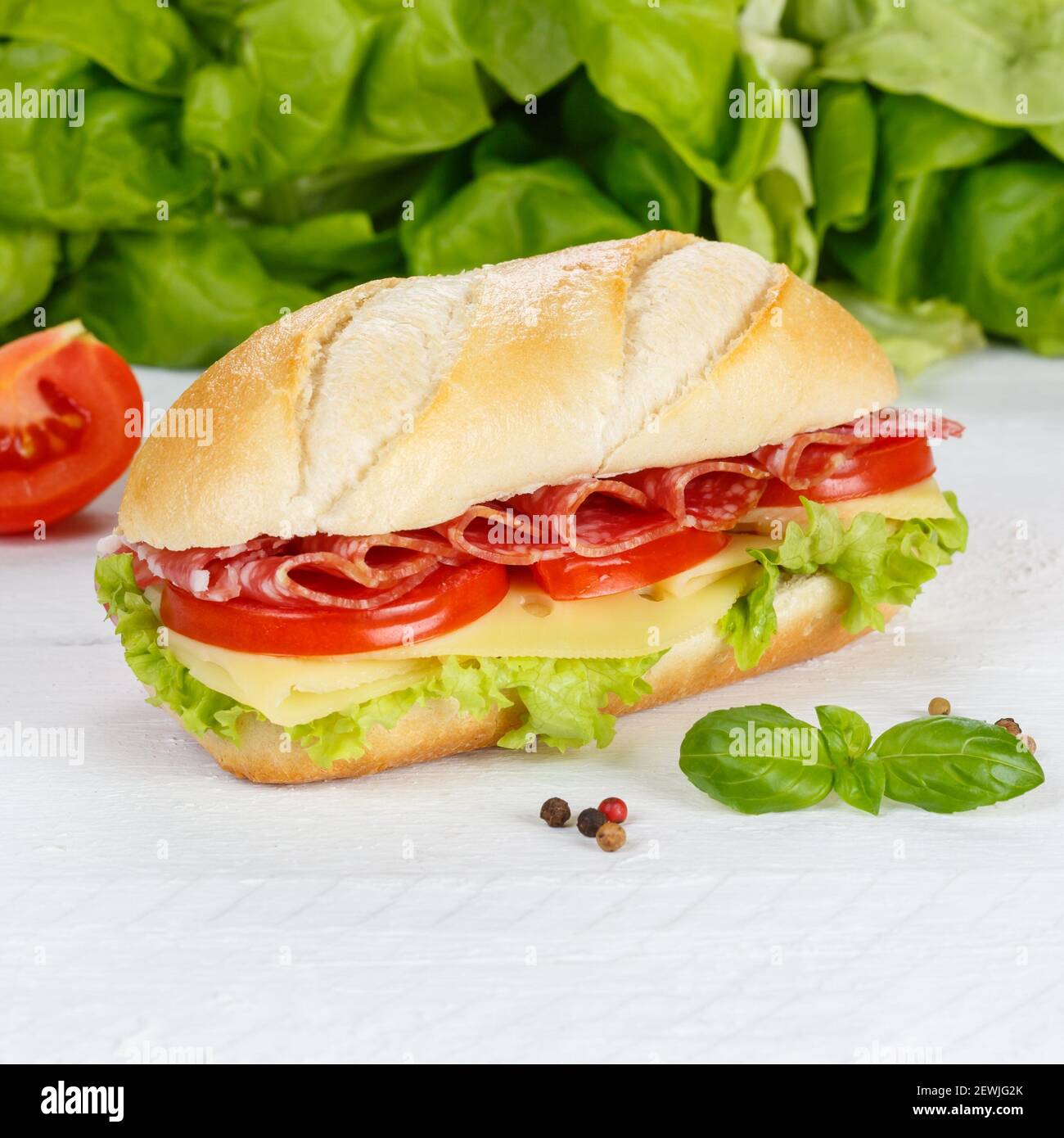 Sub sandwich with salami ham and cheese square on wooden board wood. Stock Photo