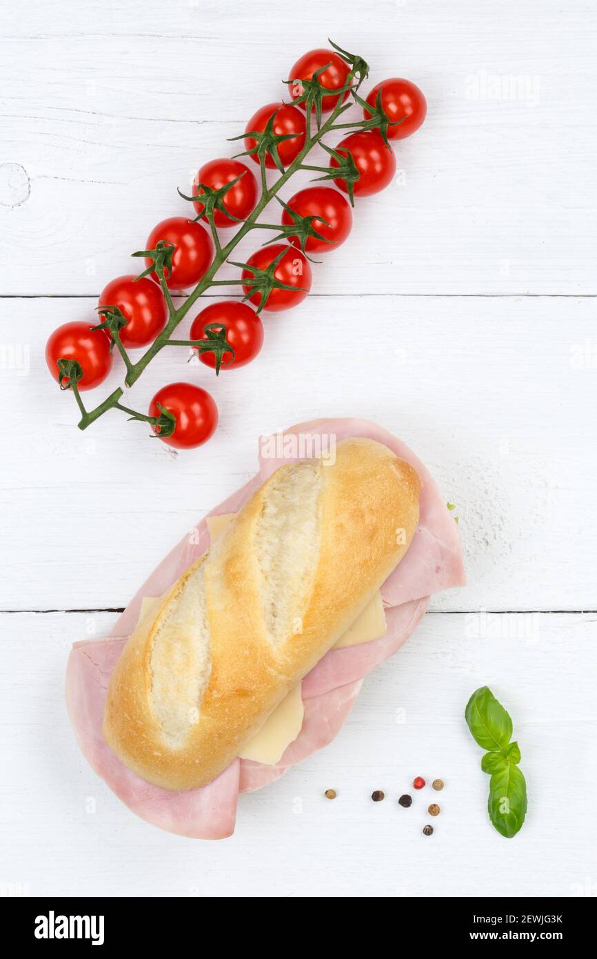 Sub sandwich with ham and cheese portrait format from above on wooden board wood. Stock Photo