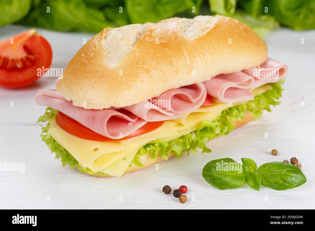 Sub sandwich with ham and cheese on wooden board wood. Stock Photo