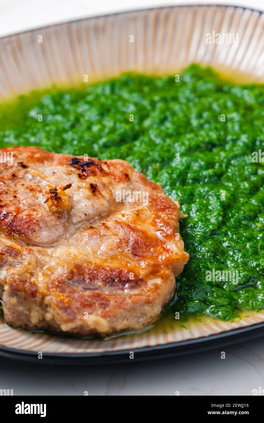 still life of pork cutlet with spinach Stock Photo Alamy