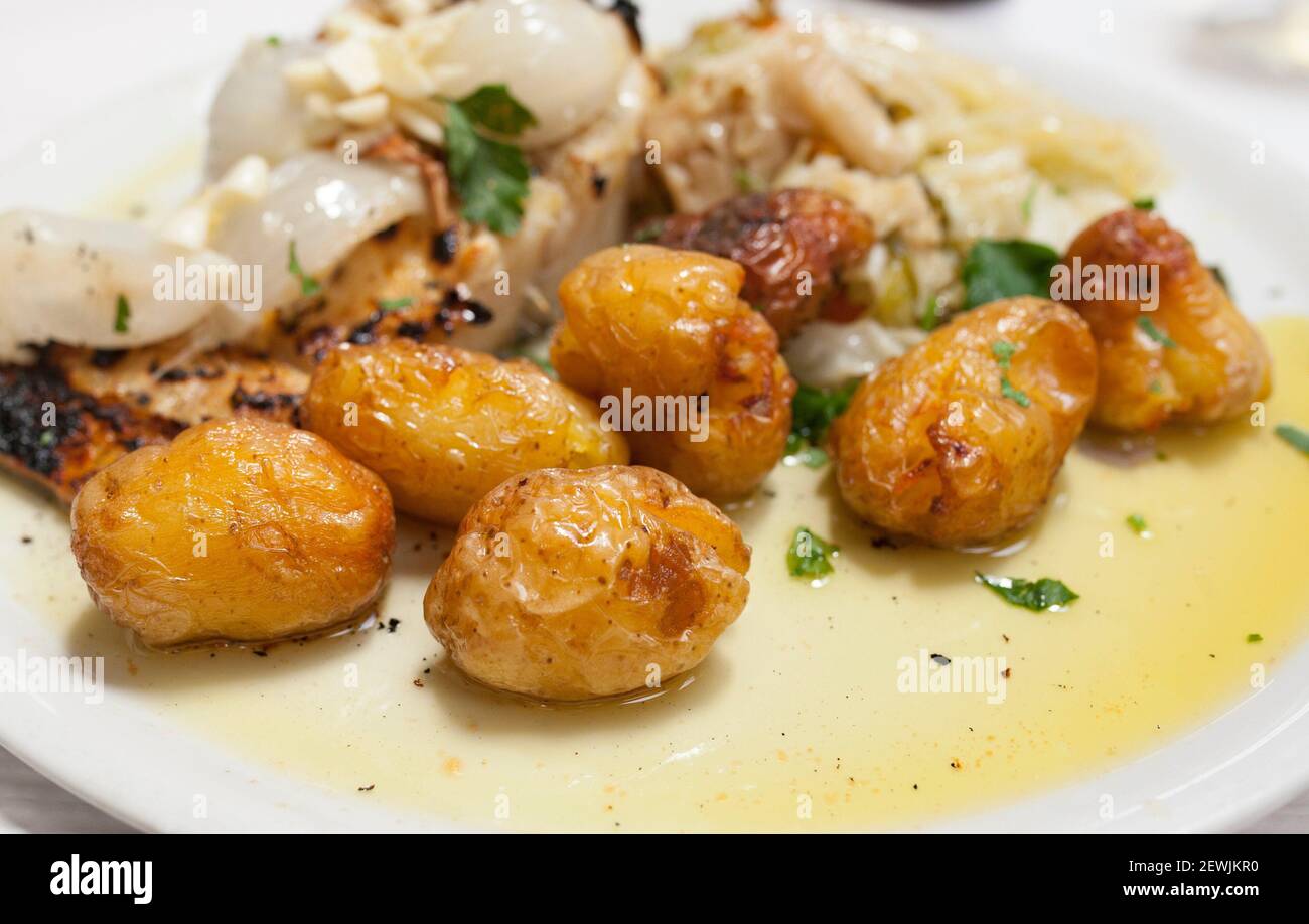 Roasted codfish with potatoes or Bacalhau a Bras. Portuguese traditional food. Stock Photo