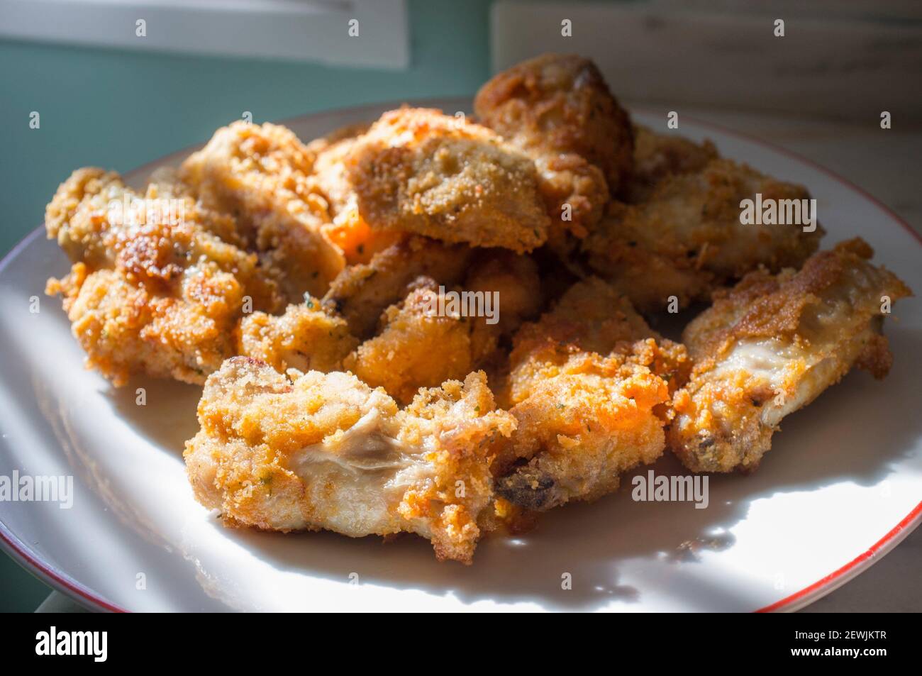 Fried bread covered chicken wings. Selective focus. Stock Photo