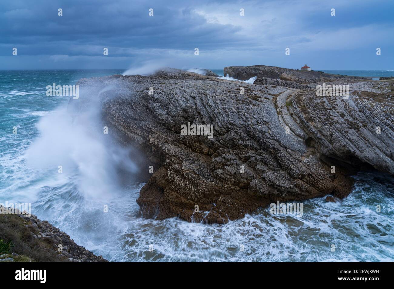 Swell and storm in the Hermitage of the Virgen del Mar in San Roman de la Llanilla in the Municipality of Santander. Virgen del Mar Island in the Stock Photo