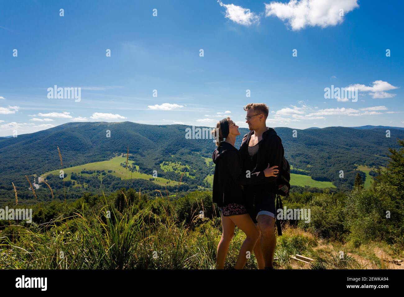 Beautifulyoung happy couple in polish Bieszczady mountains during summer. Trail from Ustrzyki via Carynska Meadow to Brzegi, Bieszczadzki Park Narodow Stock Photo