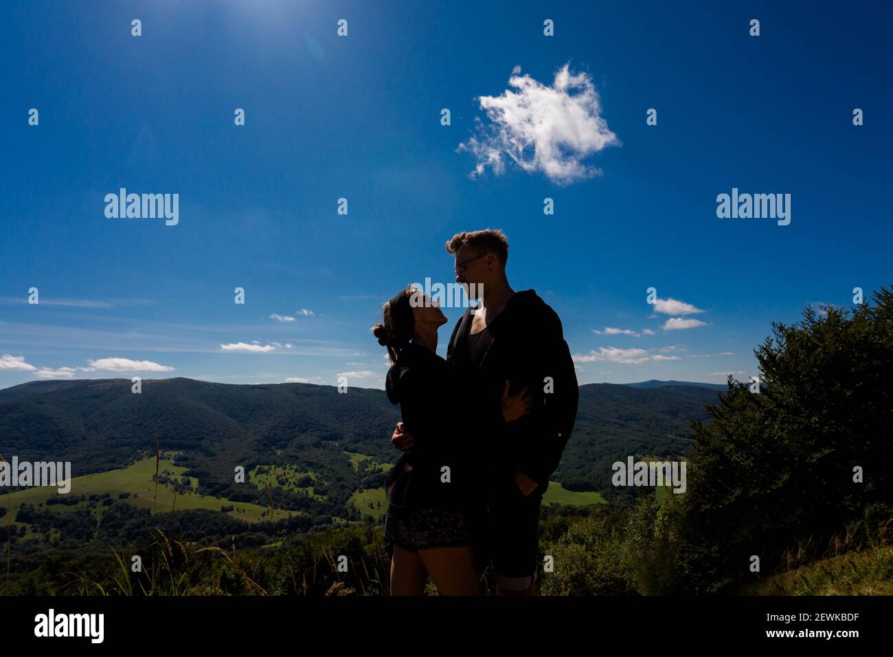 Beautifulyoung happy couple in polish Bieszczady mountains during summer. Trail from Ustrzyki via Carynska Meadow to Brzegi, Bieszczadzki Park Narodow Stock Photo