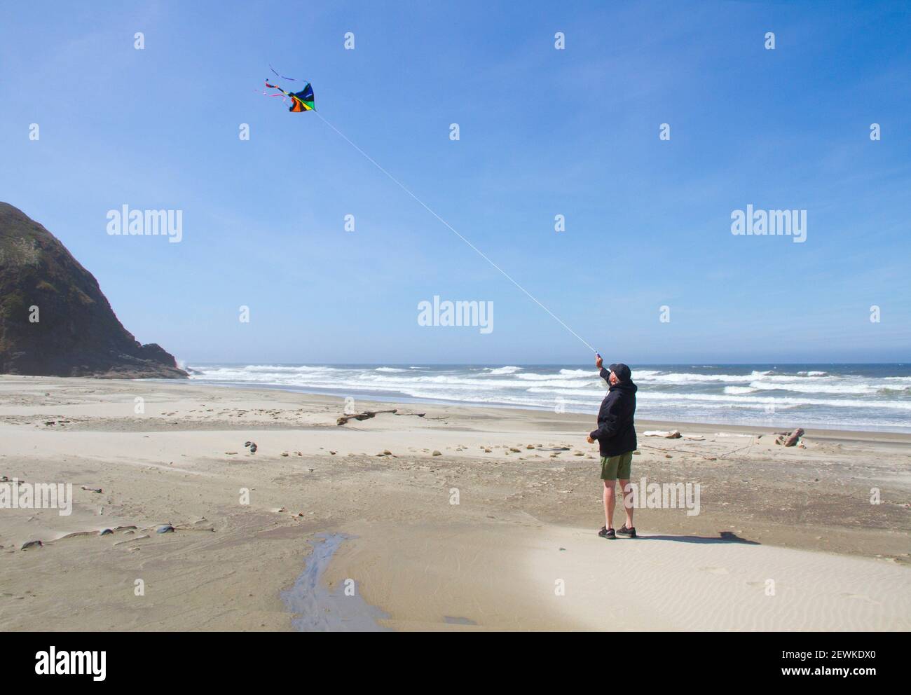 A man flies a kite on the beach near Yachats, Oregon, USA. Stock Photo
