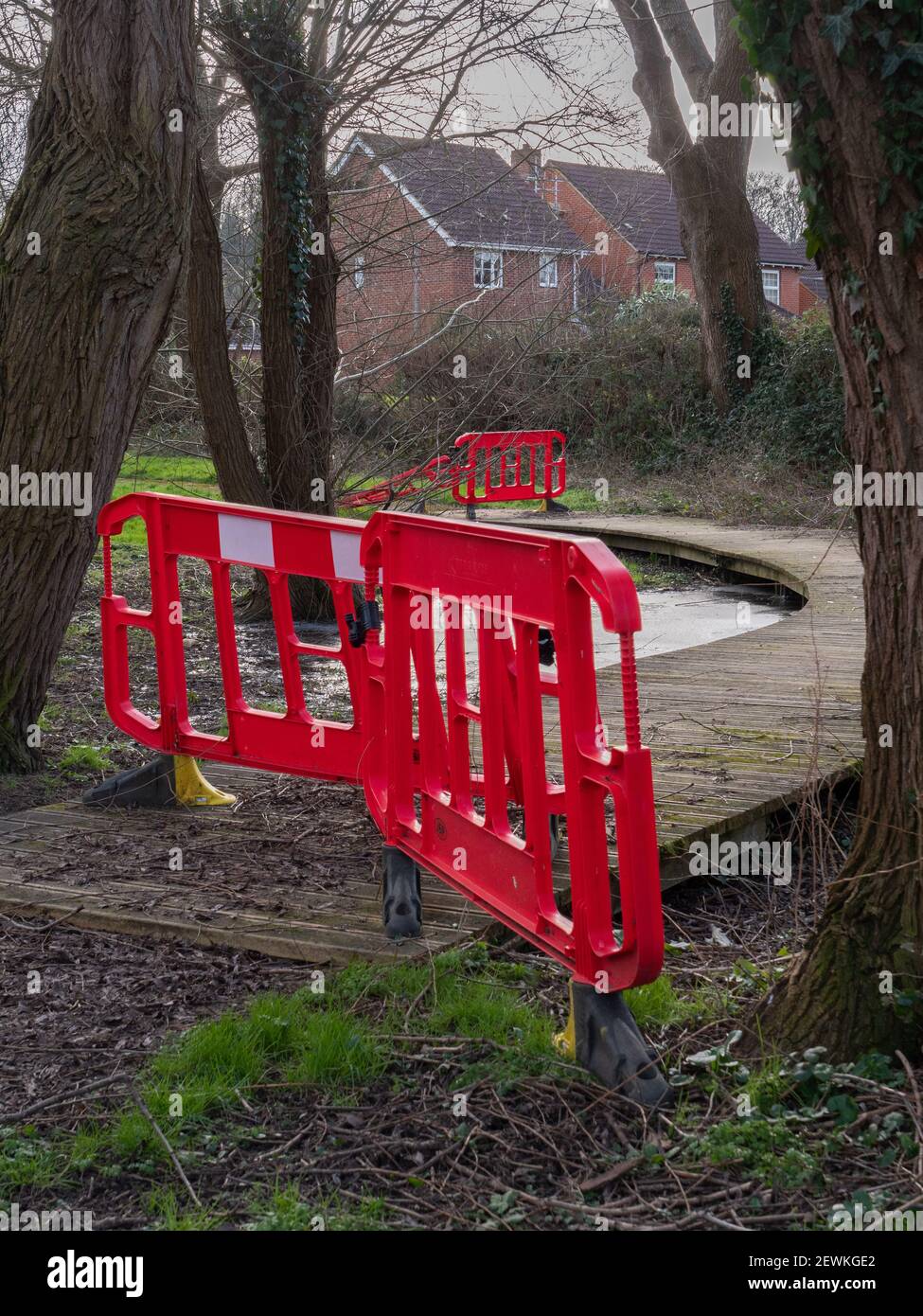 Plastic barriers in place to prevent access to potentially flooded walkway during winter months in Westbury, Wiltshire, England, UK. Stock Photo