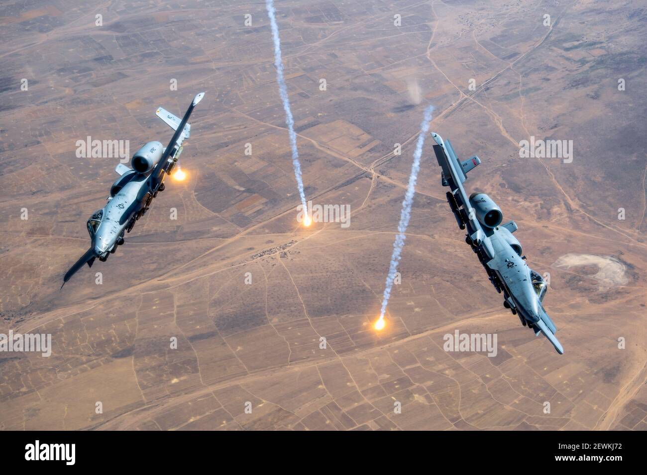 Two A-10 Thunderbolt IIs release countermeasure flares over the U. S. Central Command area of responsibility, July 23, 2020. The A-10 is a highly Stock Photo