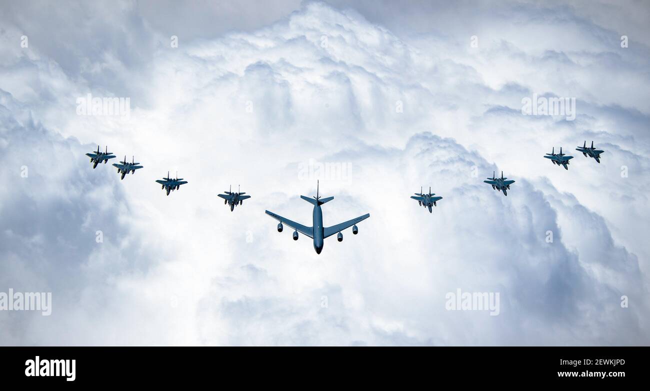 A U. S. Air Force KC-135 Stratotanker, F-15C Eagles, F-15E Strike Eagles, and Royal Saudi Air Force F-15SAs fly over Saudi Arabia while participating Stock Photo