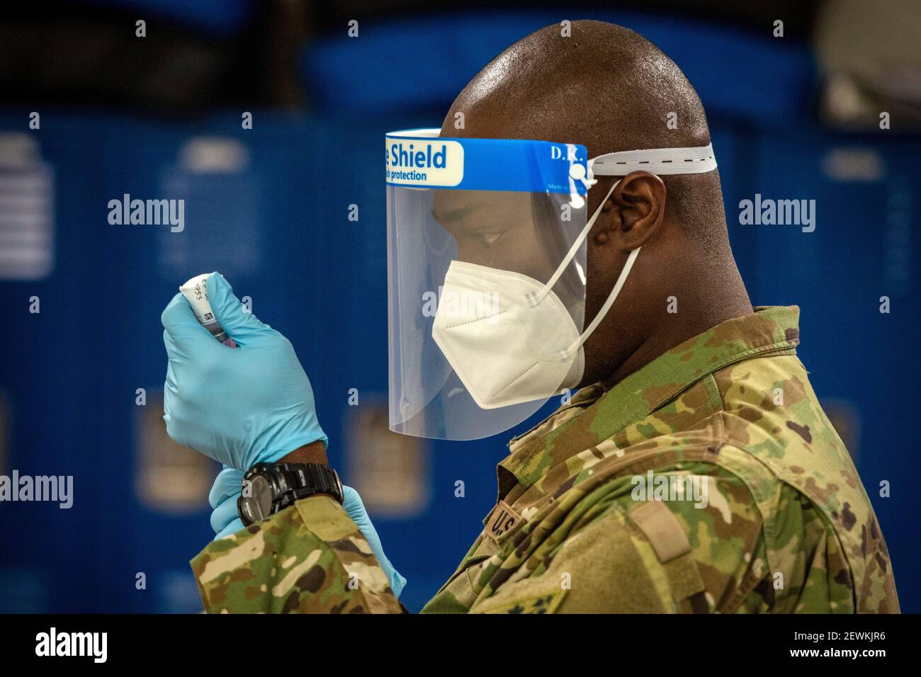 U. S. Army Staff Sgt. Donnell Niles, 192nd Engineer Battalion combat medic, draws Moderna COVID-19 vaccine from a vial into a syringe at Bradley Air Stock Photo