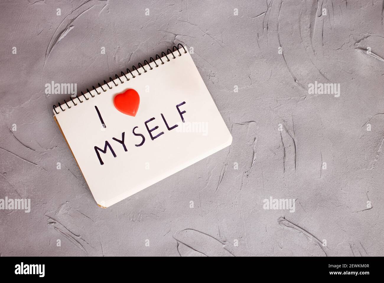 A notebook with a written phrase I love myself on grey background. Concept mental health journaling, healthy mindset, accepting myself. Stock Photo