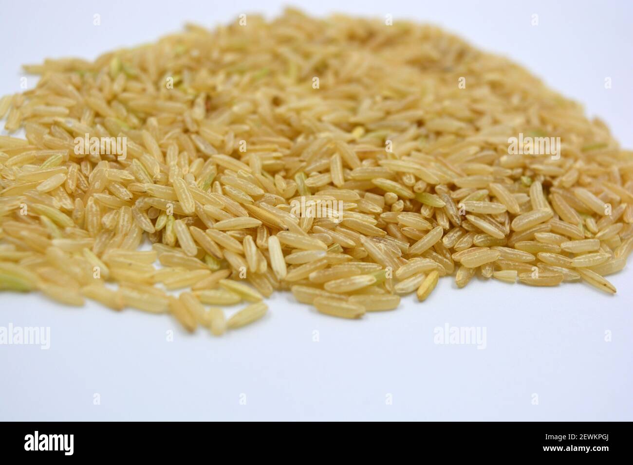 Wild unlipped white long rice raised on a white background Stock Photo ...