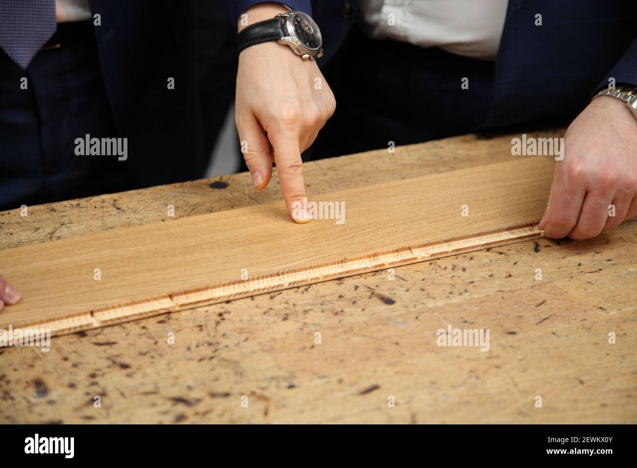 Industrial equipment for the production of laminate. Furniture factory production line. Laminated flooring.The factory for the production of laminate. Stock Photo