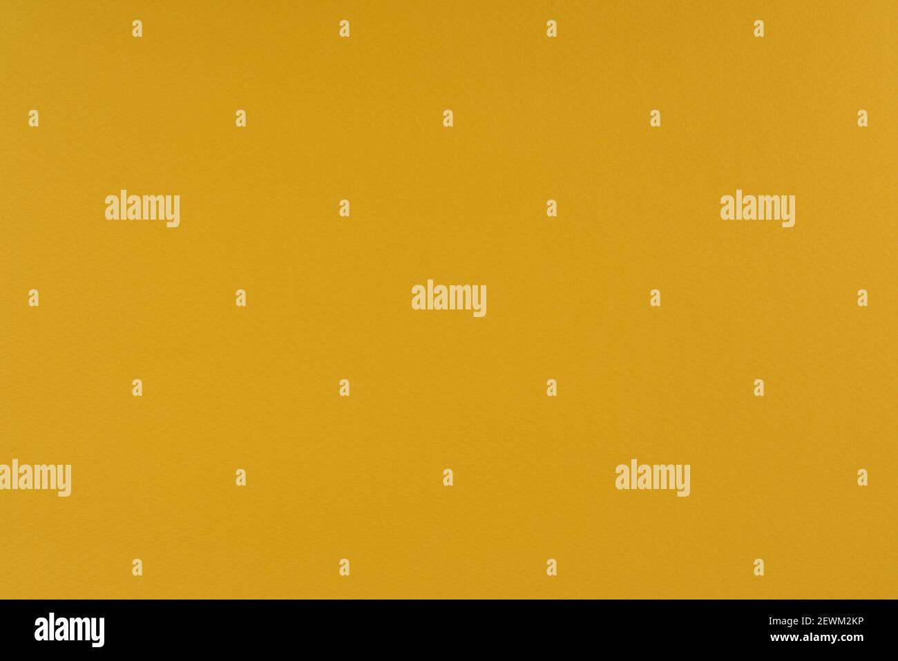 Yellow paper background. Goldenrod orange colour paper texture. Matte monochrome surface. Stock Photo