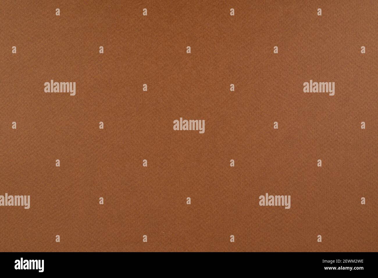 Light brown paper background. Russet brown colour paper texture. Matte monochrome surface with noises. Stock Photo