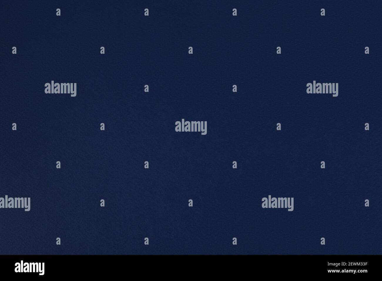 Dark blue paper background. Space blue colour paper texture. Matte monochrome surface. Stock Photo