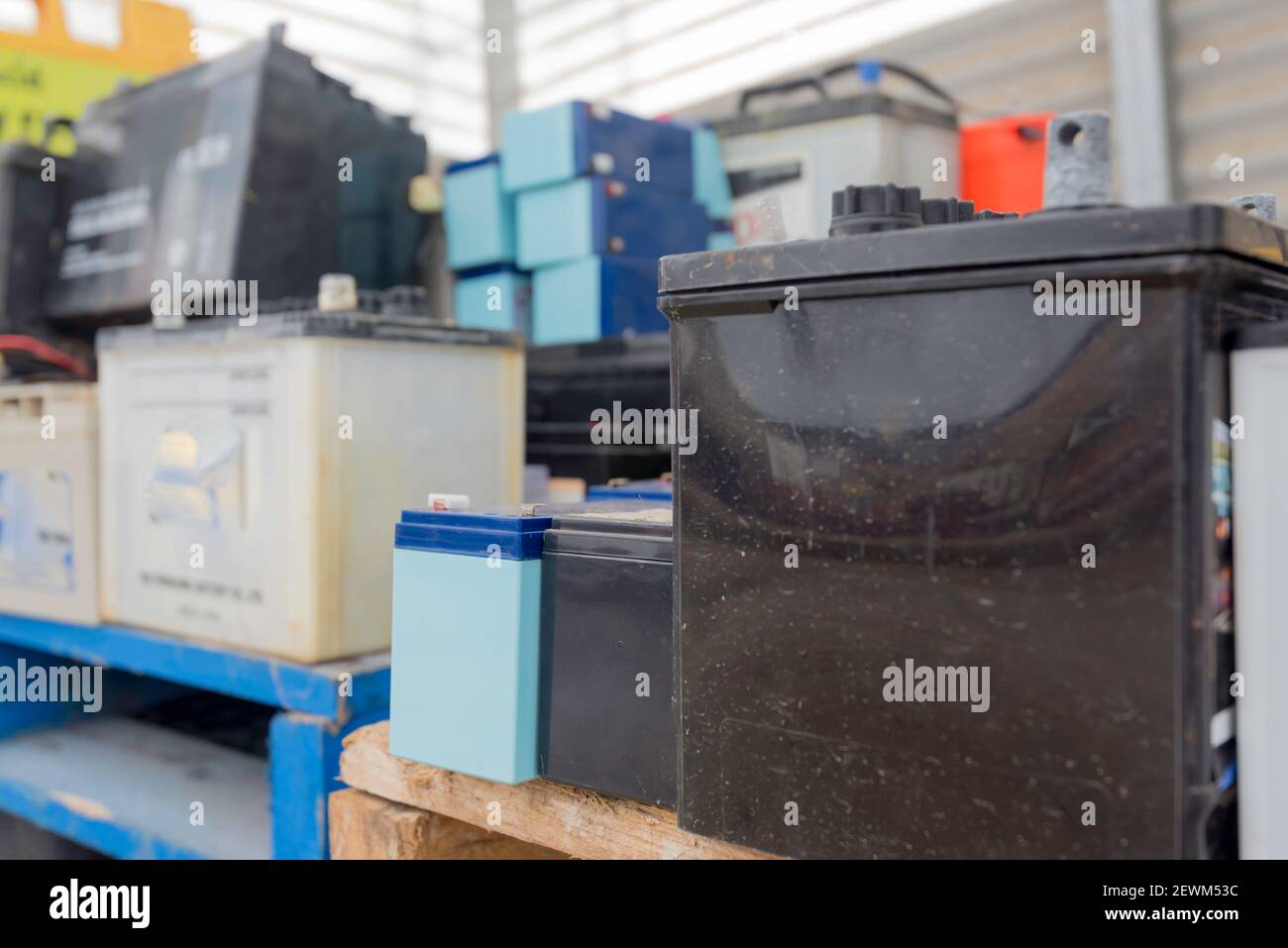 Used lead acid car and truck batteries stacked and waiting for