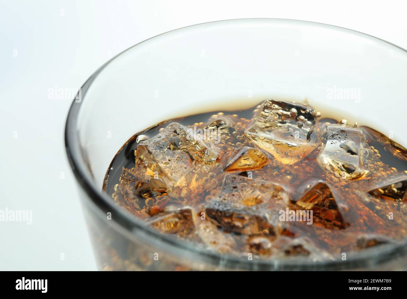 Glass of cola and ice cubes on white background, close up Stock Photo ...