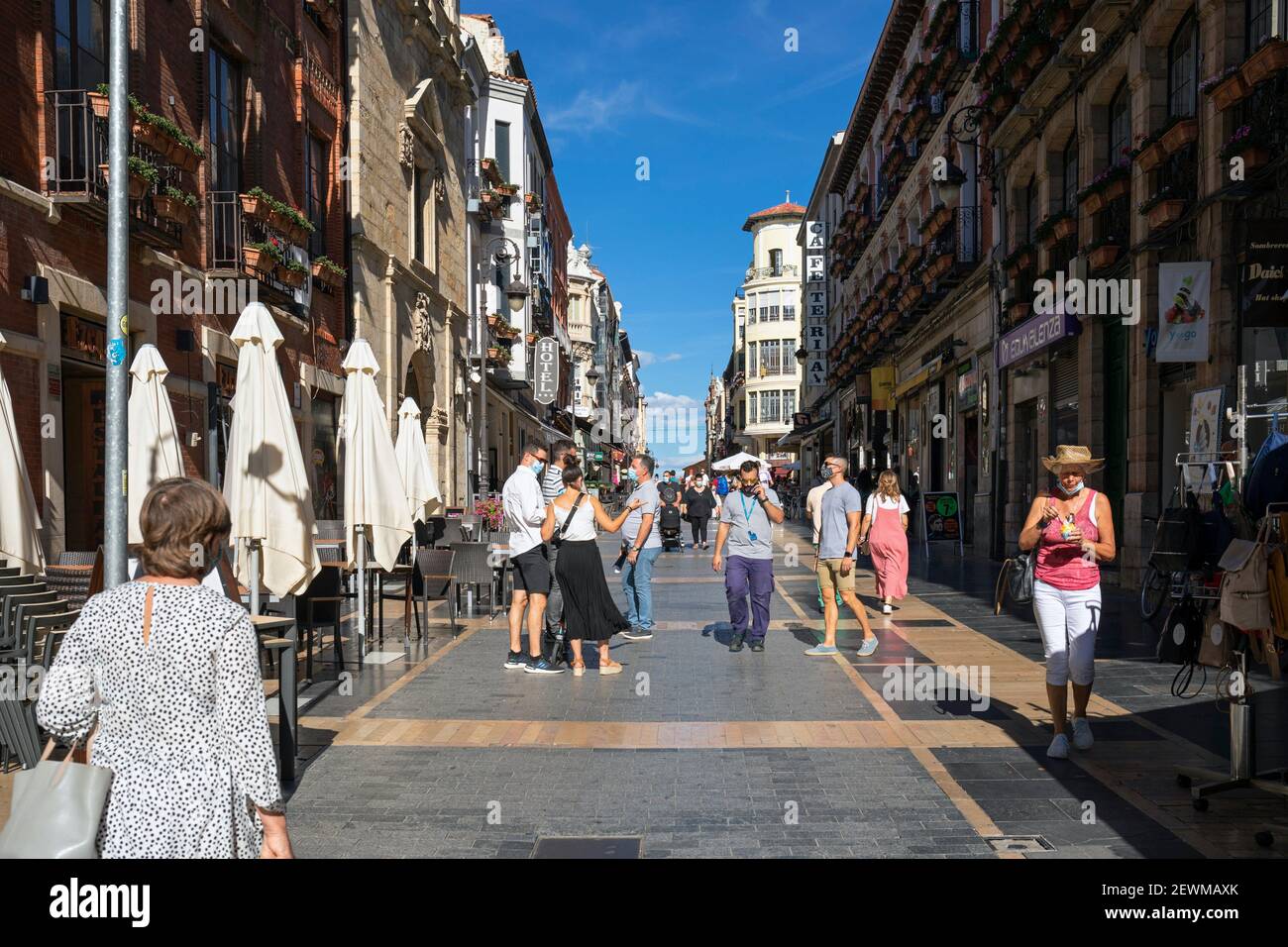 Europe, Spain, Leon, Shops and traditional architecture on Calle Ancha with tourists wearing masks during Covid-19 Pandemic Summer 2020. Stock Photo