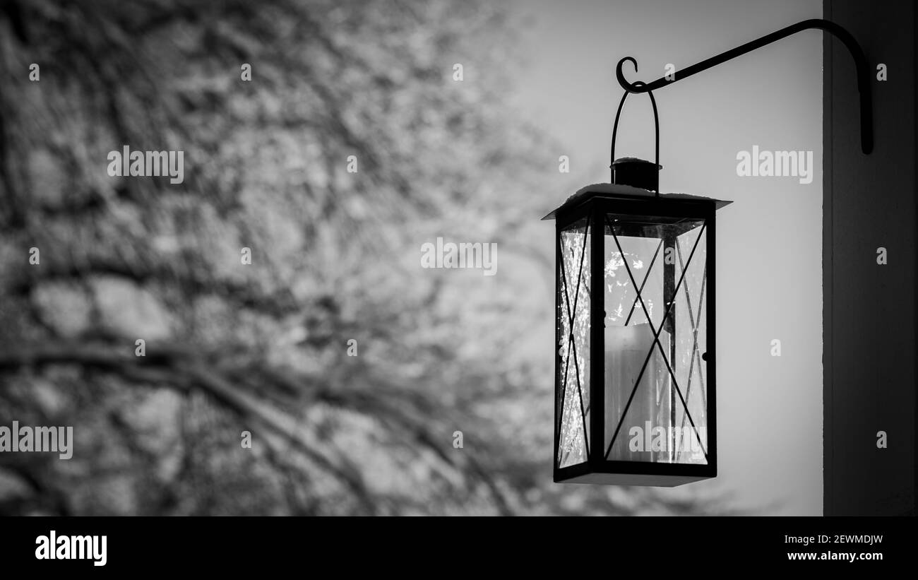 Modern lantern with frost and snowy trees in the background with negative space Stock Photo