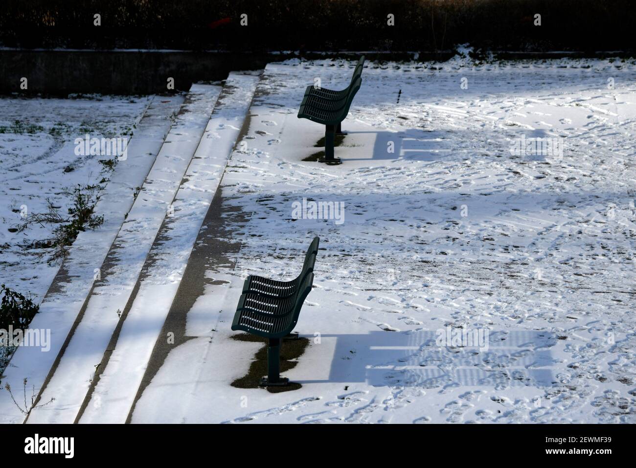 Bench on the snow, Financial District at La Defense, Paris, France. Stock Photo